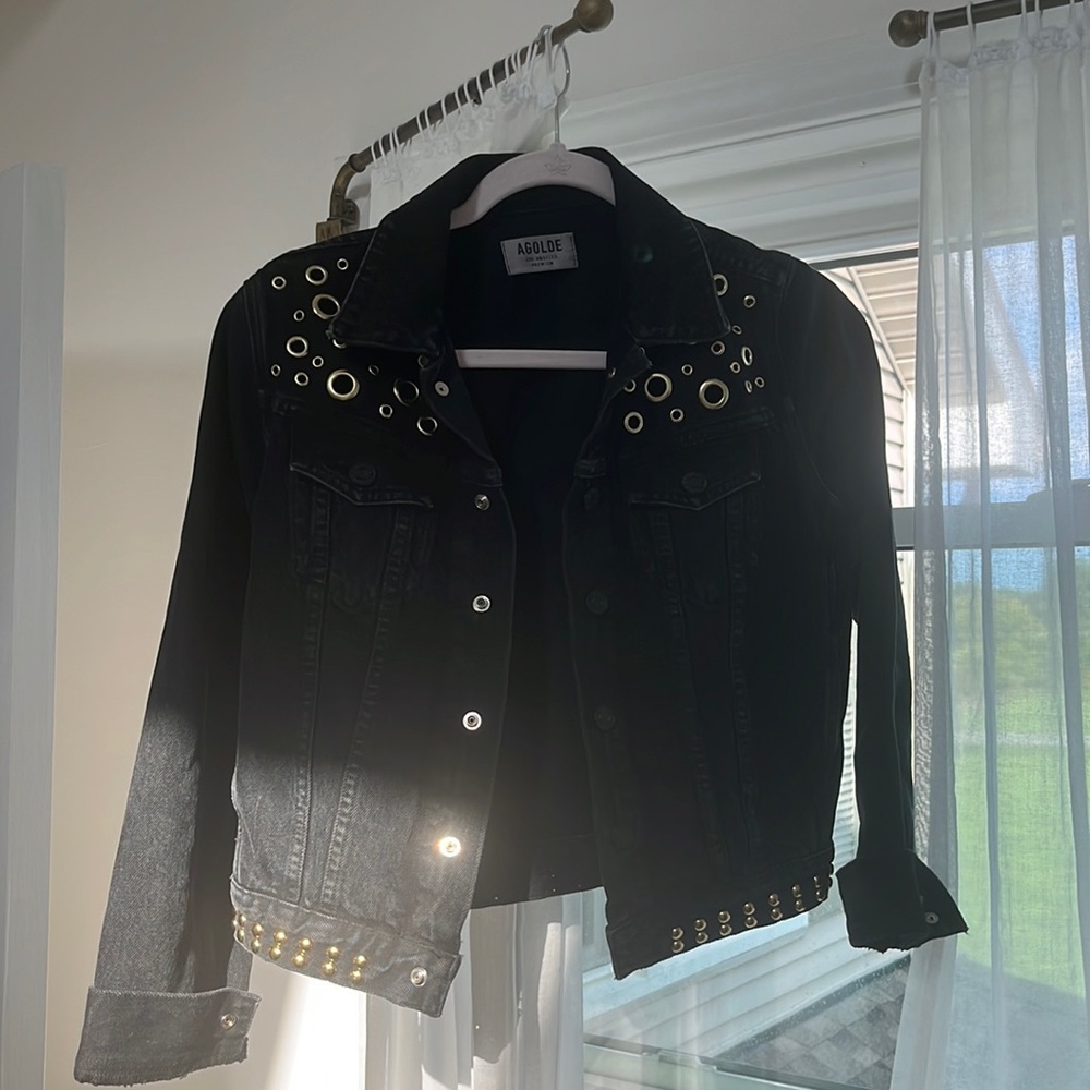Agolde black denim jacket with gold rivets.